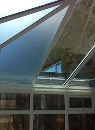 Window film installation on white conservatory